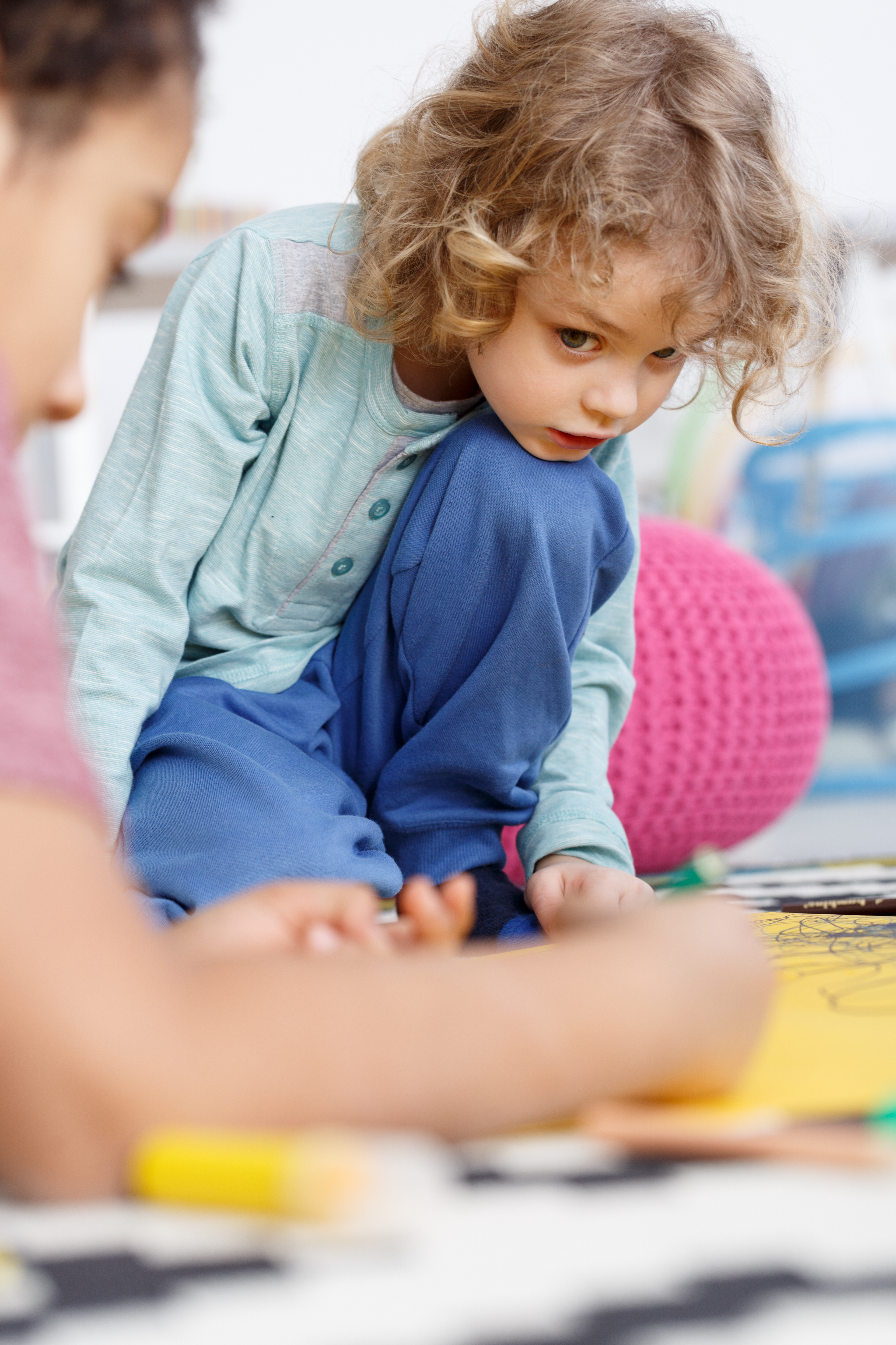 Boy painting in kindergarten
